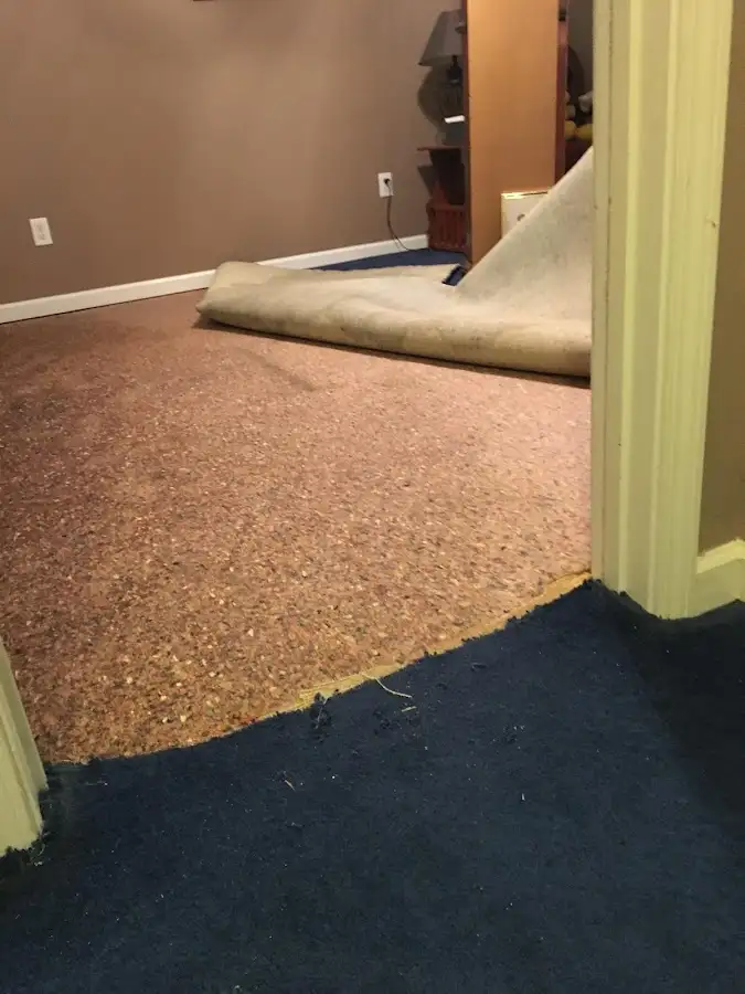 Carpet pad removal revealing water damage during Drying & Dehumidification in Augusta